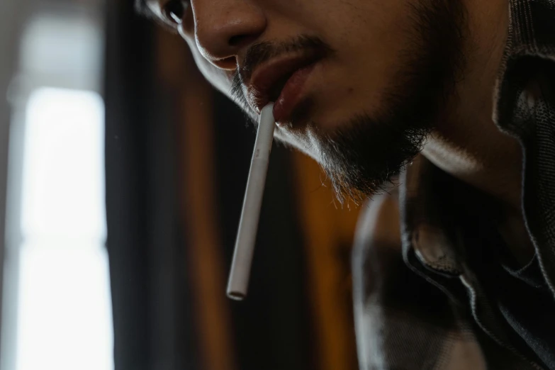 a man with a cigarette in his mouth, pexels contest winner, pete davidson, low detailed, indoor picture, thoughtful )