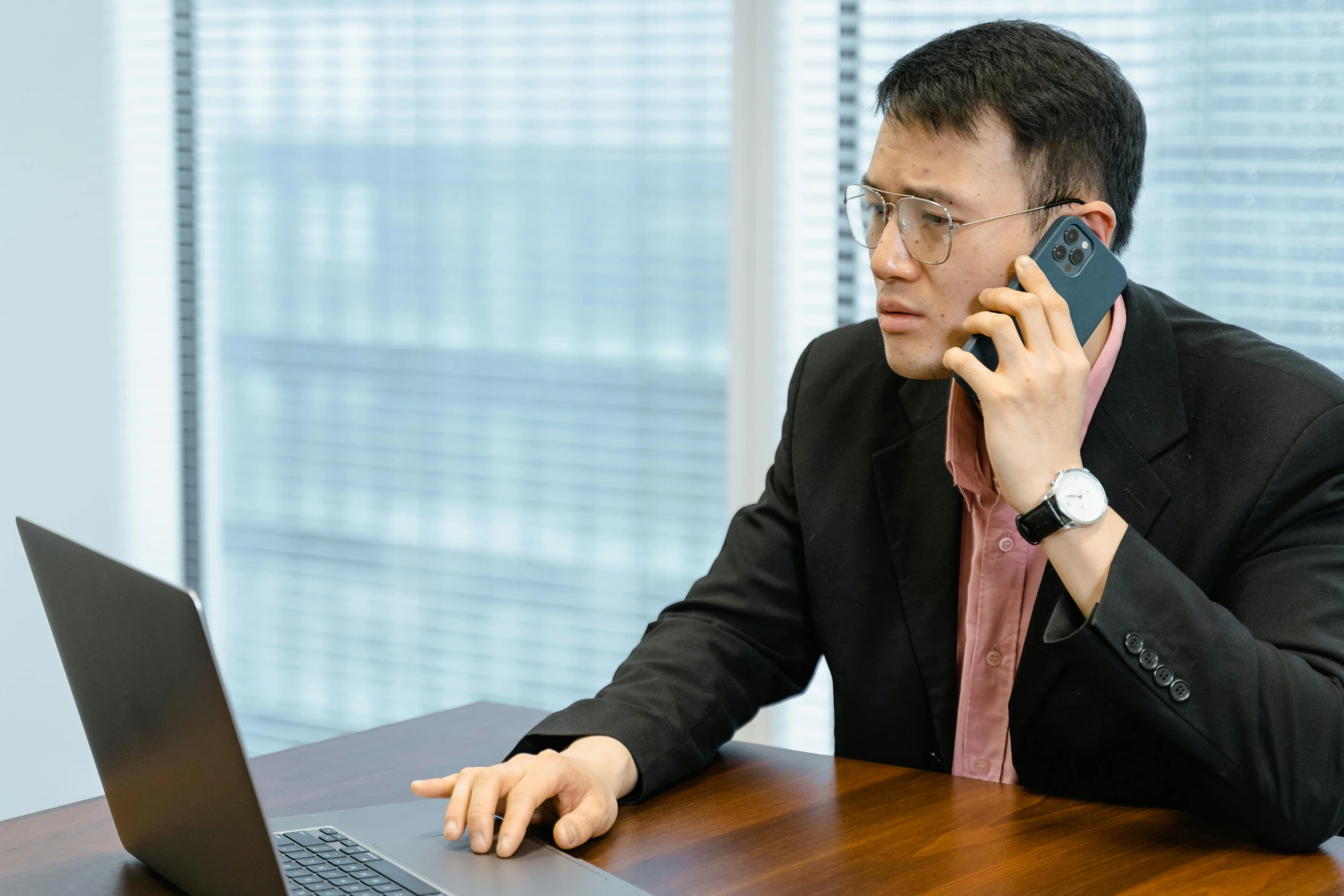 a man sitting at a table talking on a cell phone, laptops, li zixin, thumbnail, professional result