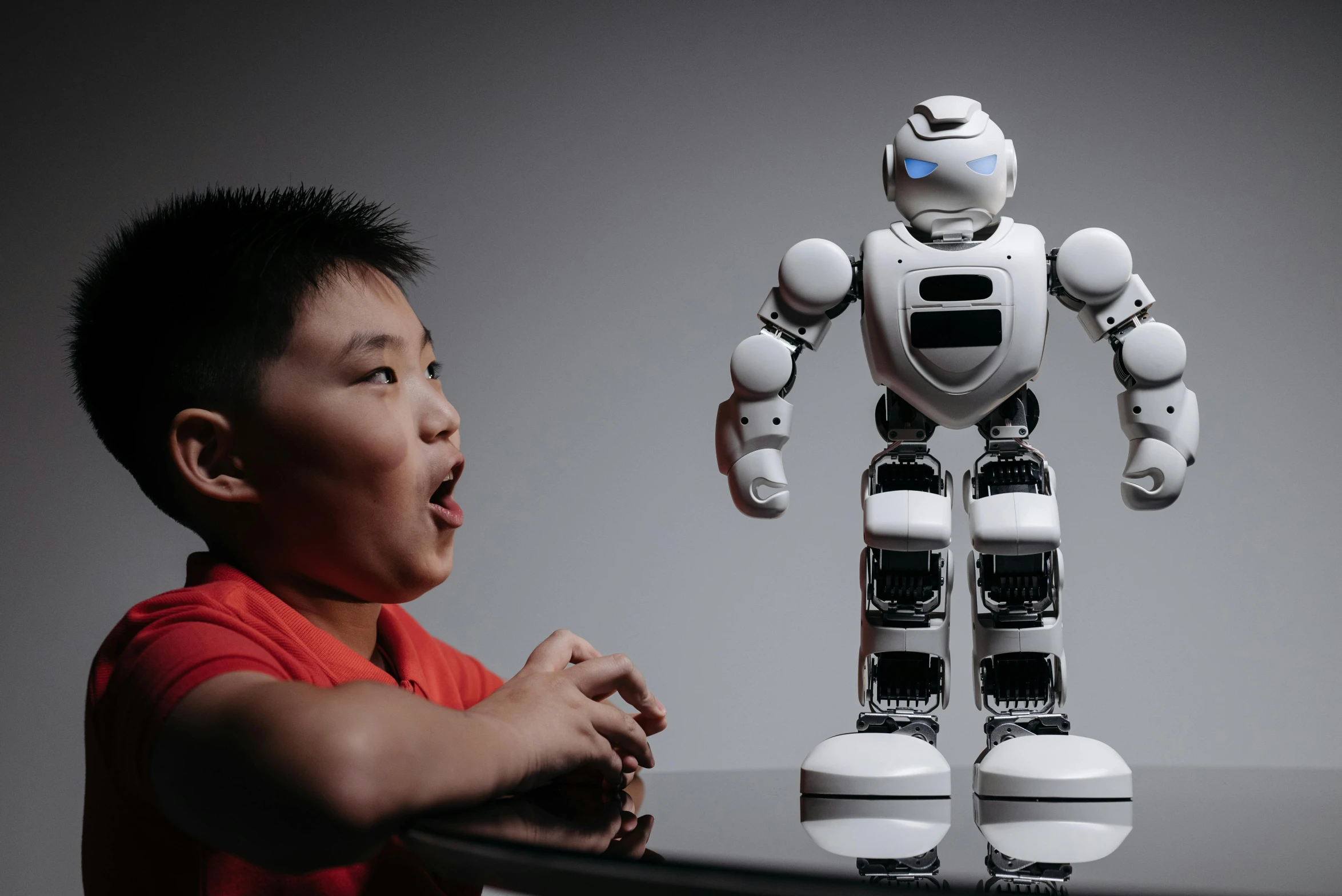 a young boy sitting in front of a robot, pexels contest winner, yanjun chengt, a person standing in front of a, expressive, giga chad