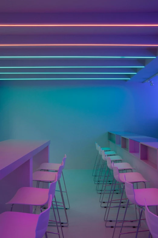 a row of bar stools in a brightly lit room, a digital rendering, inspired by Cerith Wyn Evans, trending on unsplash, light and space, purple and pink and blue neons, fluorescent ceiling lights, kitchenette and conferenceroom, glowing hue of teal