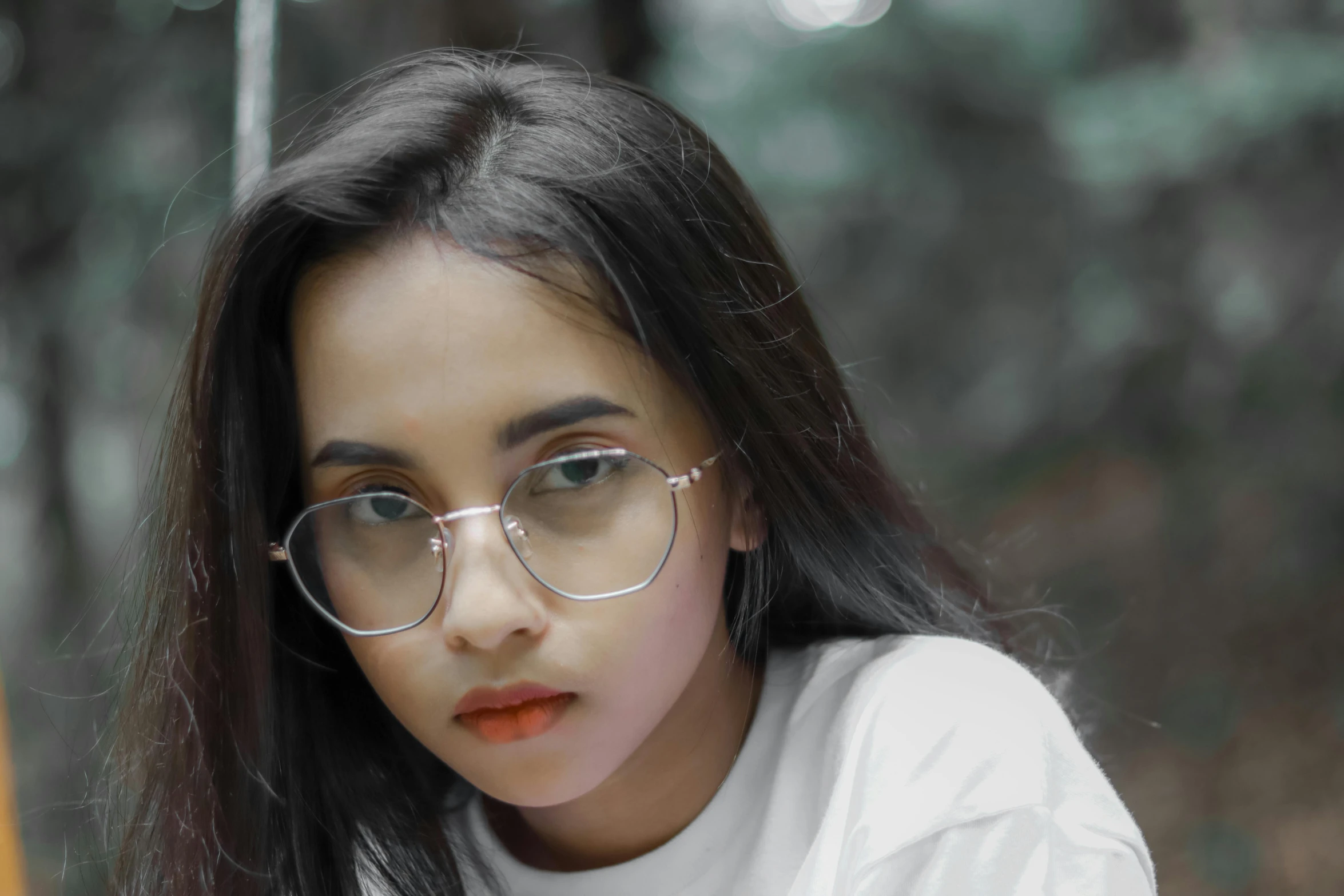 a close up of a person wearing glasses, inspired by Elsa Bleda, trending on pexels, indian girl with brown skin, wearing casual clothing, south east asian with round face, glossy photo