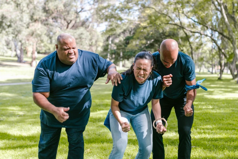 a group of people standing on top of a lush green field, morbidly obese, knockout punch, sydney park, they are crouching