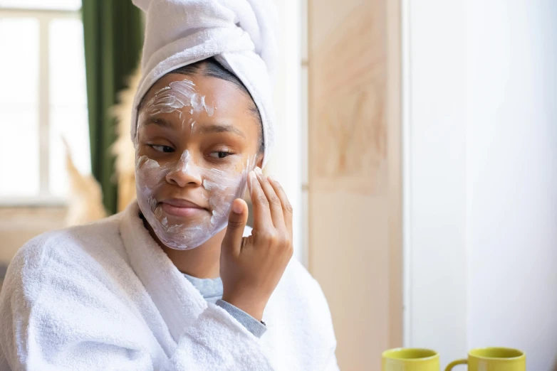 a woman with a towel on her head shaving her face, a portrait, trending on pexels, manuka, thumbnail, late morning, candy treatments