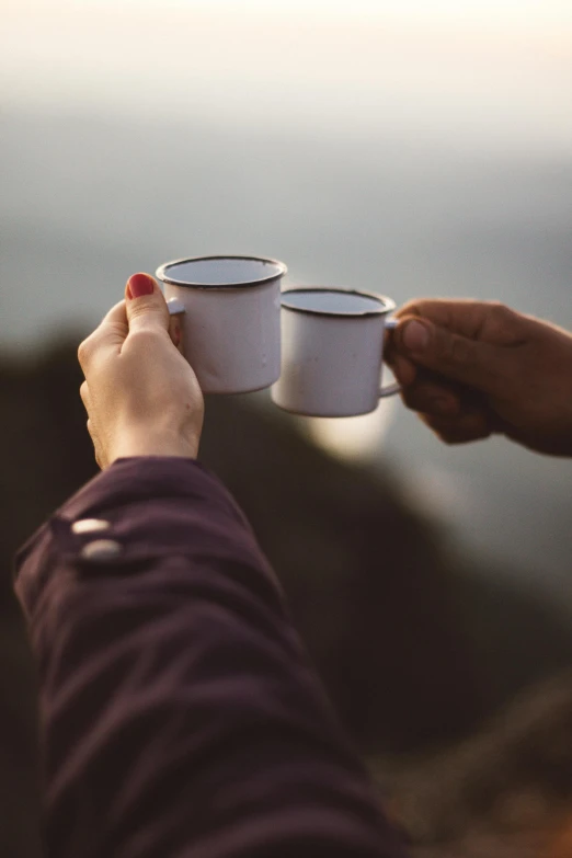 two people holding cups of coffee on top of a mountain, pexels contest winner, romanticism, white mug, grey, amanda lilleston, evening light