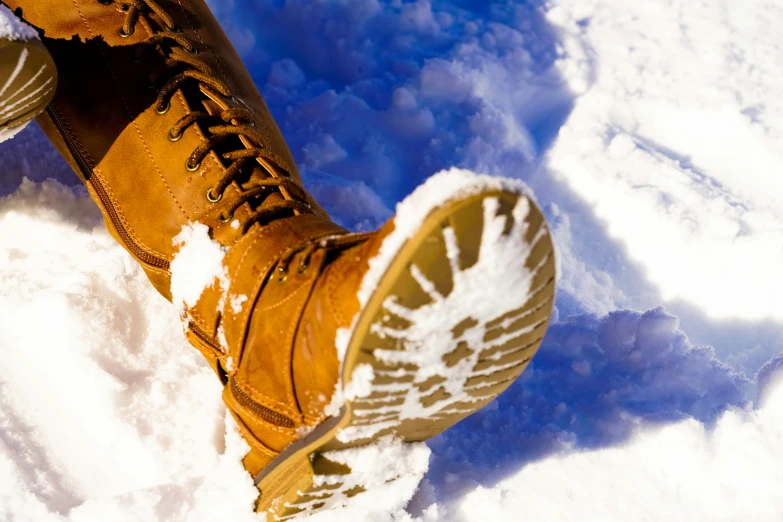 a person standing in the snow wearing brown boots, pexels, avatar image, close up image, thumbnail, bright sunny day