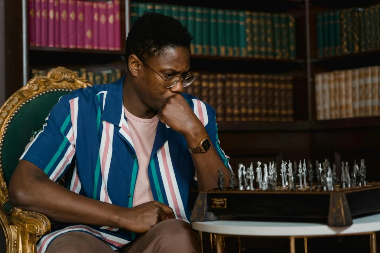a man sitting in a chair playing a game of chess, inspired by Barthélemy Menn, pexels contest winner, kehinde wiley, youtube thumbnail, looking to his side, daniel oxford