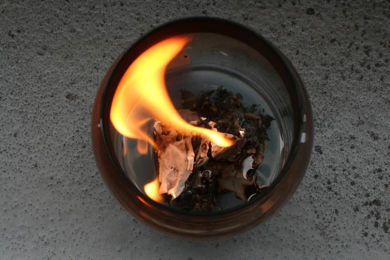 a burning piece of wood in a glass of water, an album cover, unsplash, process art, gas lanterns, copper oxide material, ceremonial ritual, photograph taken in 2 0 2 0