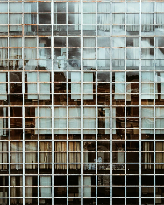 a very tall building with a lot of windows, a mosaic, inspired by Andreas Gursky, pexels contest winner, hotel room, square lines, transparent, burning building