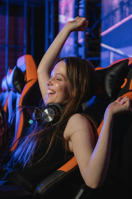 a woman sitting in a chair with headphones on, featured on reddit, ecstatic crowd, sierra entertainment games, black and orange, softplay