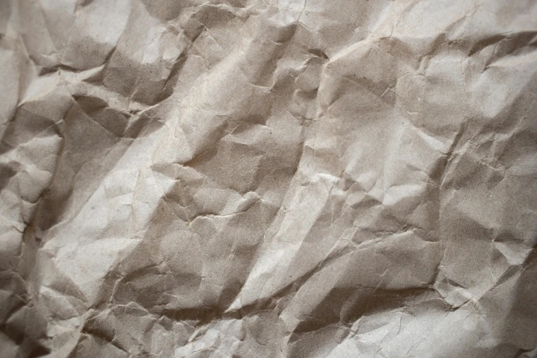 a close up of a piece of paper on a table, trending on pexels, wrinkled, taupe, background image, delicious