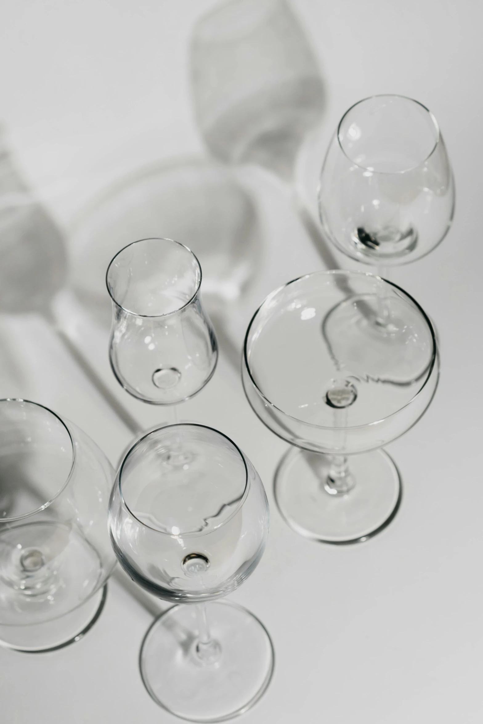 a number of empty wine glasses on a table, a still life, by Carey Morris, trending on unsplash, minimalism, detailed white, made out of glass, detailed product image, detail shot