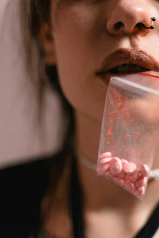 a woman brushing her teeth with a toothbrush, by Adam Marczyński, trending on pexels, hyperrealism, made of candy, pills, pink, kiss mouth to mouth