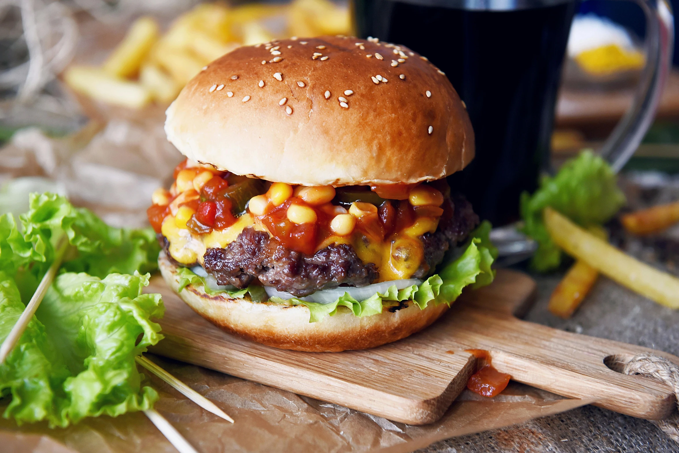 a hamburger sitting on top of a wooden cutting board, a picture, epicurious, thumbnail, ketchup, recipe