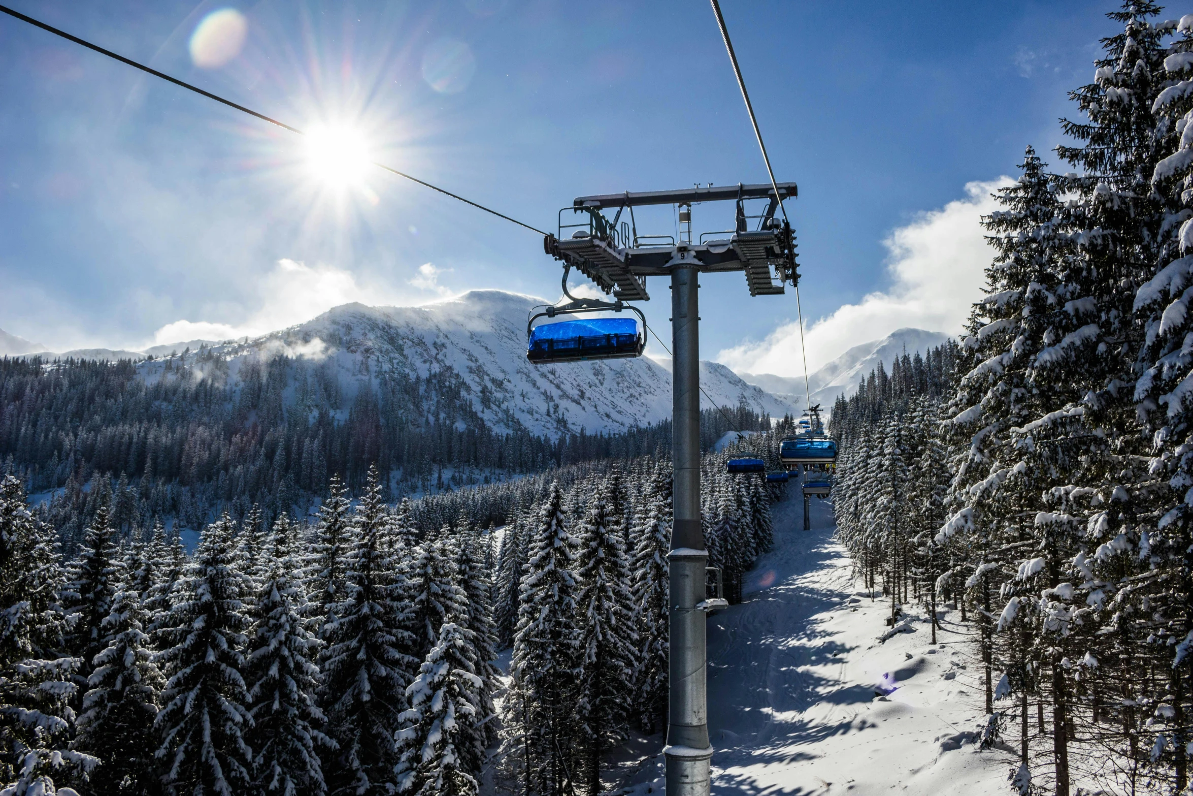 a ski lift going up to the top of a mountain, by Matthias Stom, pexels contest winner, bauhaus, avatar image, sunny winter day, polish, thumbnail