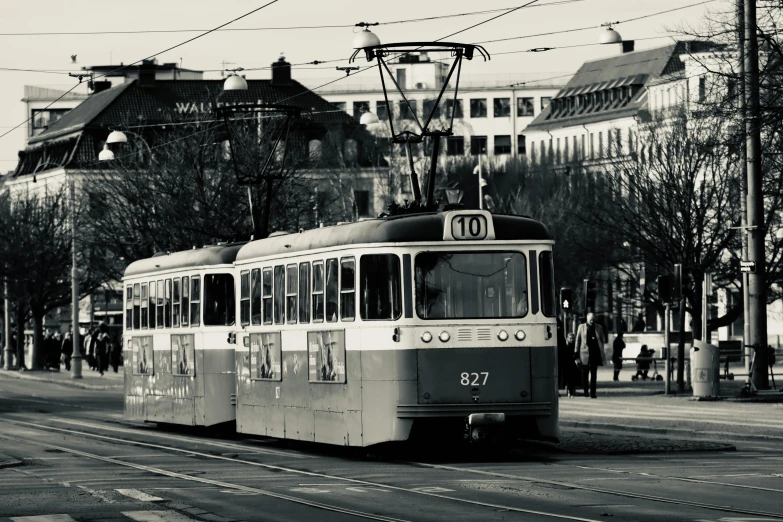 a black and white photo of a trolley on a city street, inspired by Emil Bisttram, pexels contest winner, cool sepia tone colors, square, helsinki, trams