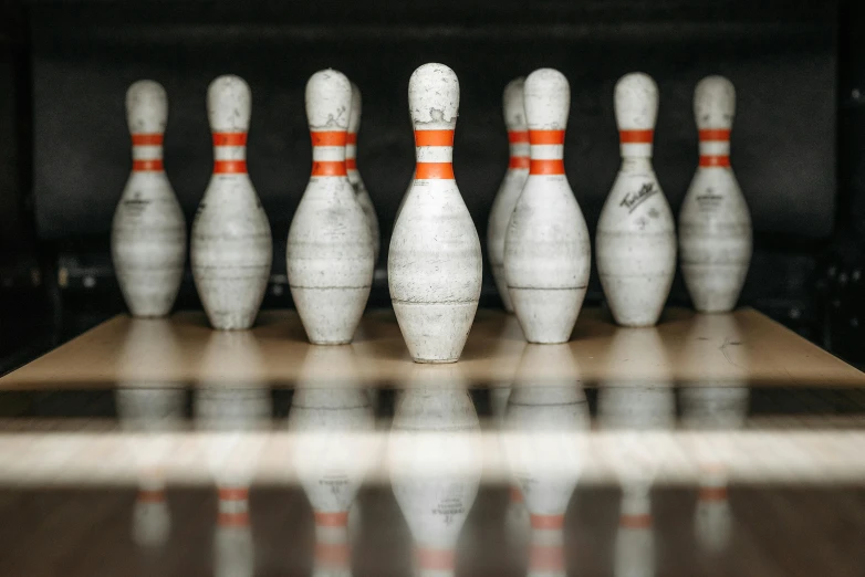 a row of bowling pins sitting on top of a wooden table