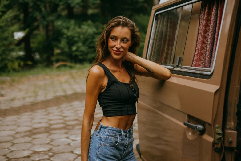 a beautiful young woman standing next to a van, by Emma Andijewska, pexels contest winner, wearing a black cropped tank top, avatar image, wearing jeans, 7 0 s photo