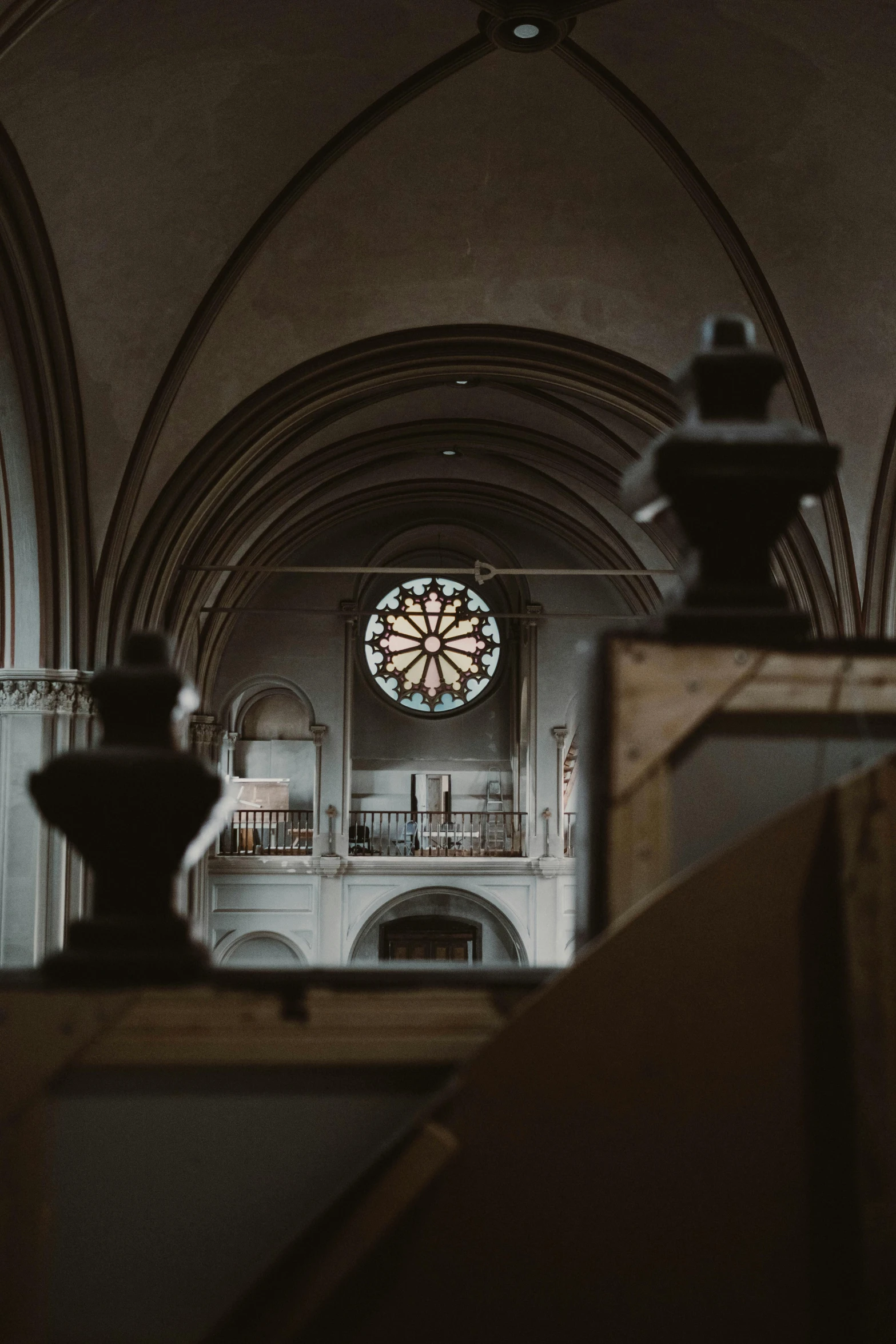 the inside of a church with a stained glass window, a marble sculpture, unsplash contest winner, romanesque, round windows, seen from a distance, brown, trending photo