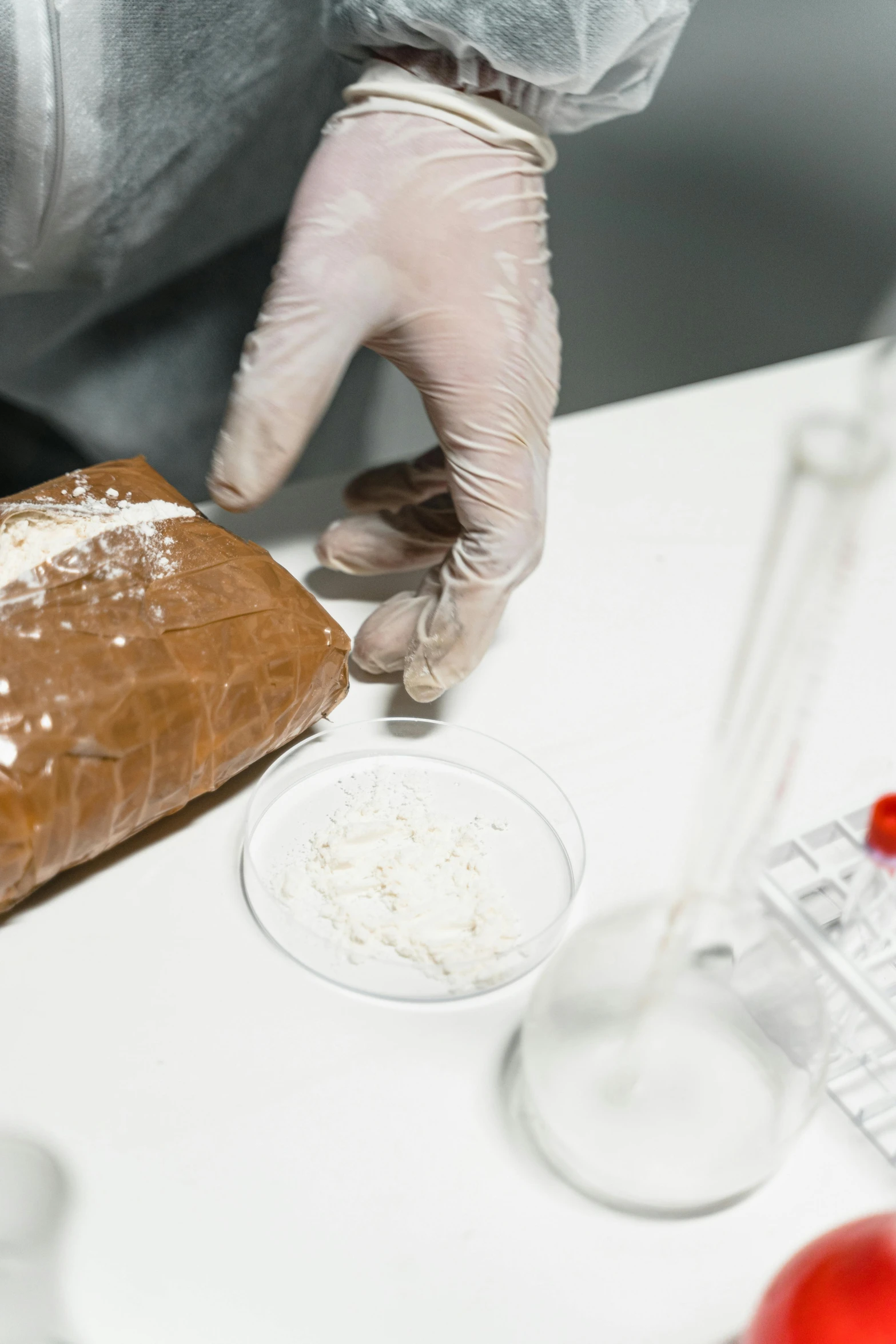 a close up of a person preparing food on a table, reagents, covered in white flour, scientific paper, holding meatloaf