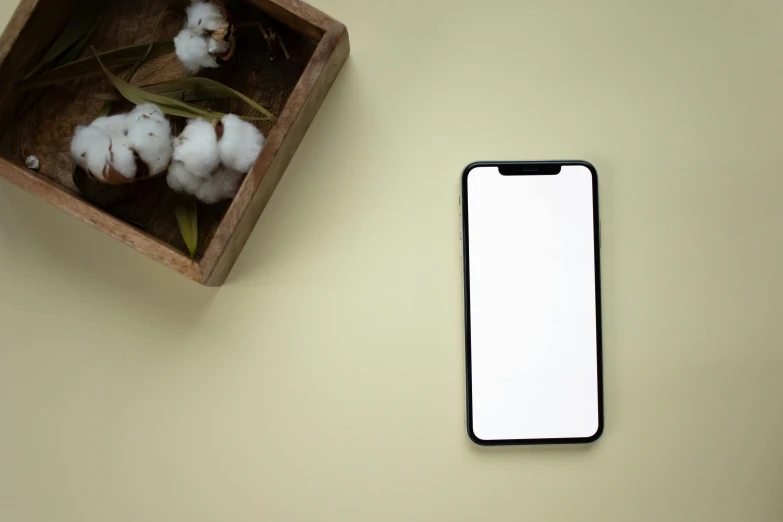 a cell phone sitting on top of a wooden box, a minimalist painting, trending on pexels, minimalism, background image, lined in cotton, 8k selfie photograph, large screen