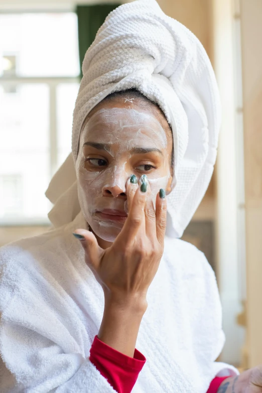 a woman with a towel on her head shaving her face, trending on pexels, renaissance, portrait of ororo munroe, black eye mask, partially cupping her hands, morning glow