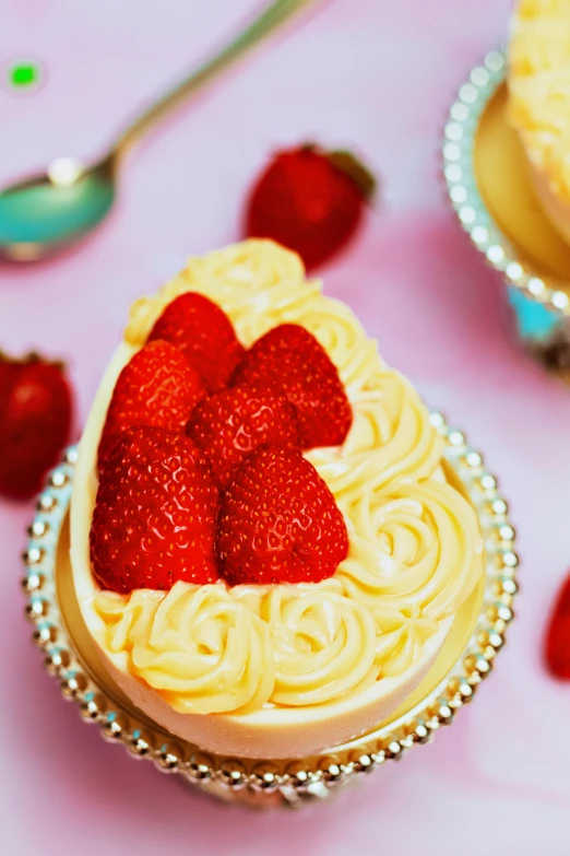 a couple of cupcakes sitting on top of a table, next to sliced strawberries, dressed in ornate, sea of parfait, curves