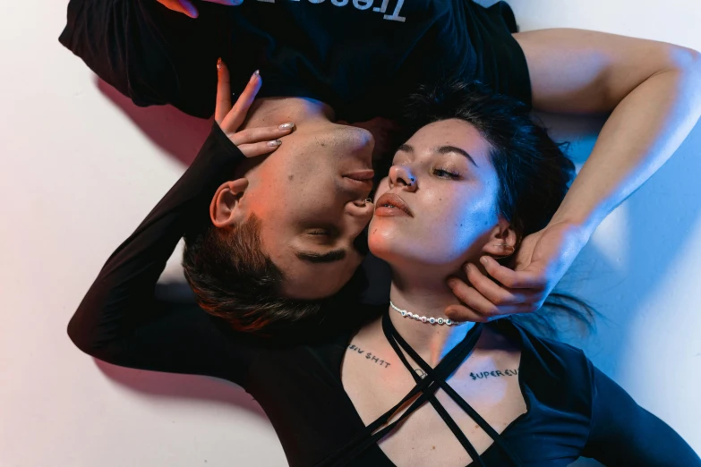 a man and a woman laying on top of each other, inspired by Elsa Bleda, trending on pexels, aestheticism, wearing black choker, charli xcx, cai xukun, studio lit