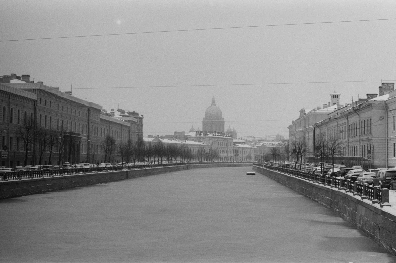 a black and white photo of a snowy street, a black and white photo, by Maurycy Gottlieb, flickr, socialist realism, building along a river, saint petersburg, 000 — википедия, springtime