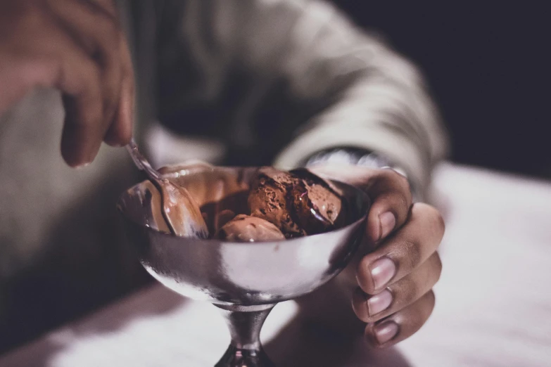 a person holding a spoon over a bowl of ice cream, by Adam Marczyński, trending on unsplash, renaissance, fully chocolate, gentlemens dinner, shiny crisp finish, thumbnail