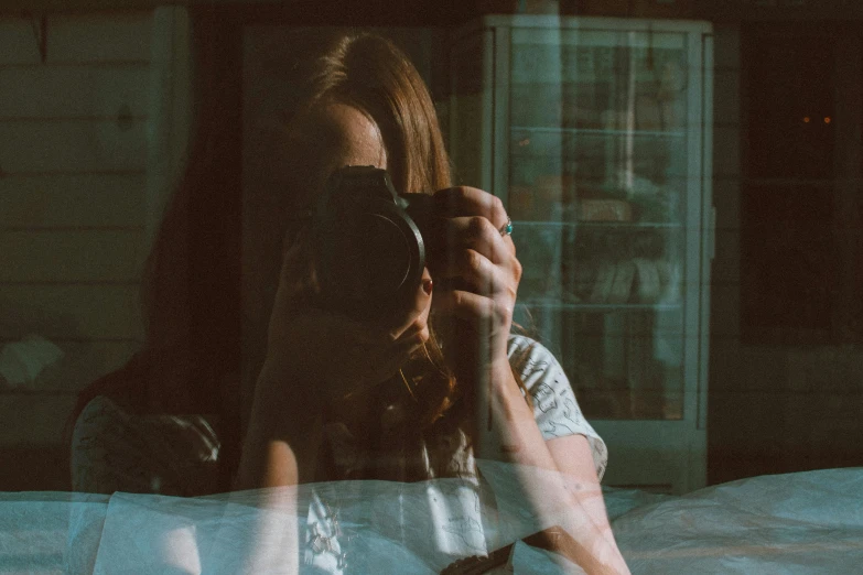 a woman taking a picture of a cat with a camera, a picture, inspired by Elsa Bleda, pexels contest winner, visual art, looking in mirror, looking in the window, selfie of a young woman, grainy low quality