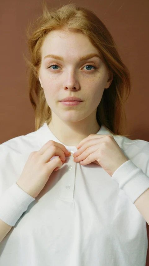 a close up of a person wearing a white shirt, inspired by Louisa Matthíasdóttir, wearing polo shirt, pale skin, anna podedworna, press photos