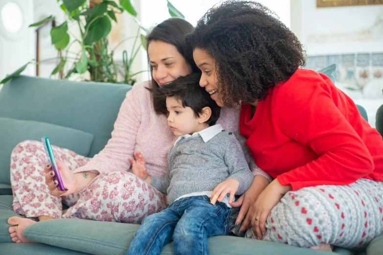 a woman and two children sitting on a couch, pexels, avatar image, lgbtq, netflix, instagram picture