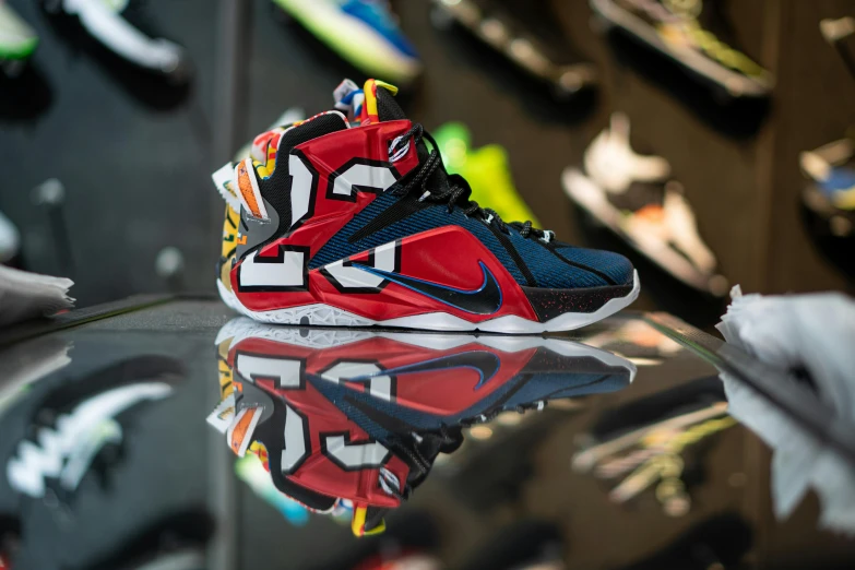 a pair of sneakers sitting on top of a glass table, toyism, lebron james, blue and red two - tone, front profile shot, sales