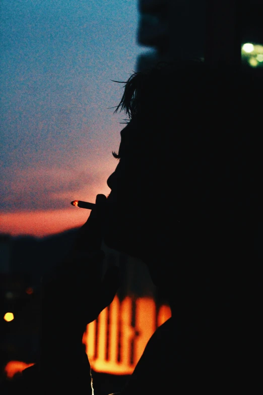 a silhouette of a person smoking a cigarette, pexels contest winner, happening, lo fi colors, sunfaded, (night), burned