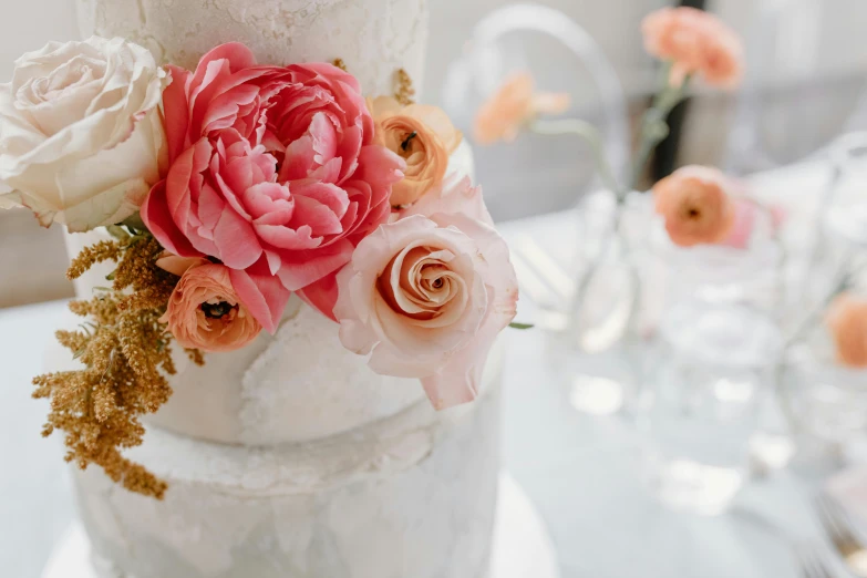 a close up of a wedding cake on a table, a marble sculpture, by Liza Donnelly, trending on unsplash, pink orange flowers, thumbnail, sydney hanson, peony flowers