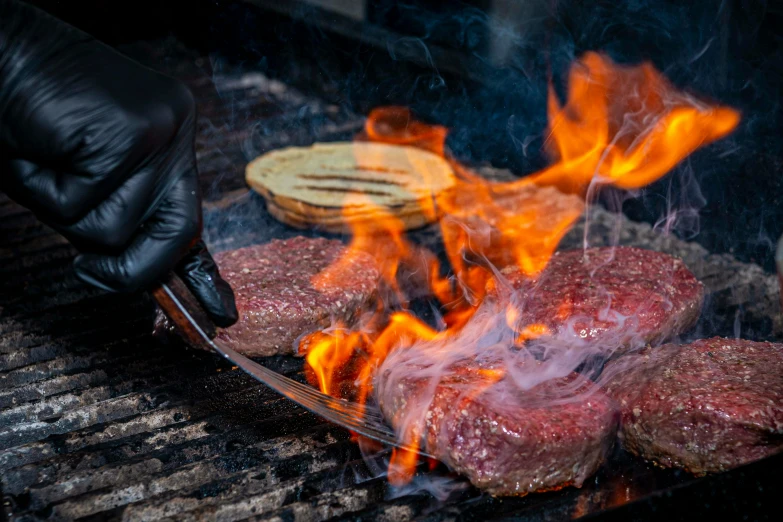 a steak being cooked on a grill with flames, by Julia Pishtar, pexels contest winner, tentacles wrapped around burgers, chopping hands, avatar image, full body close-up shot