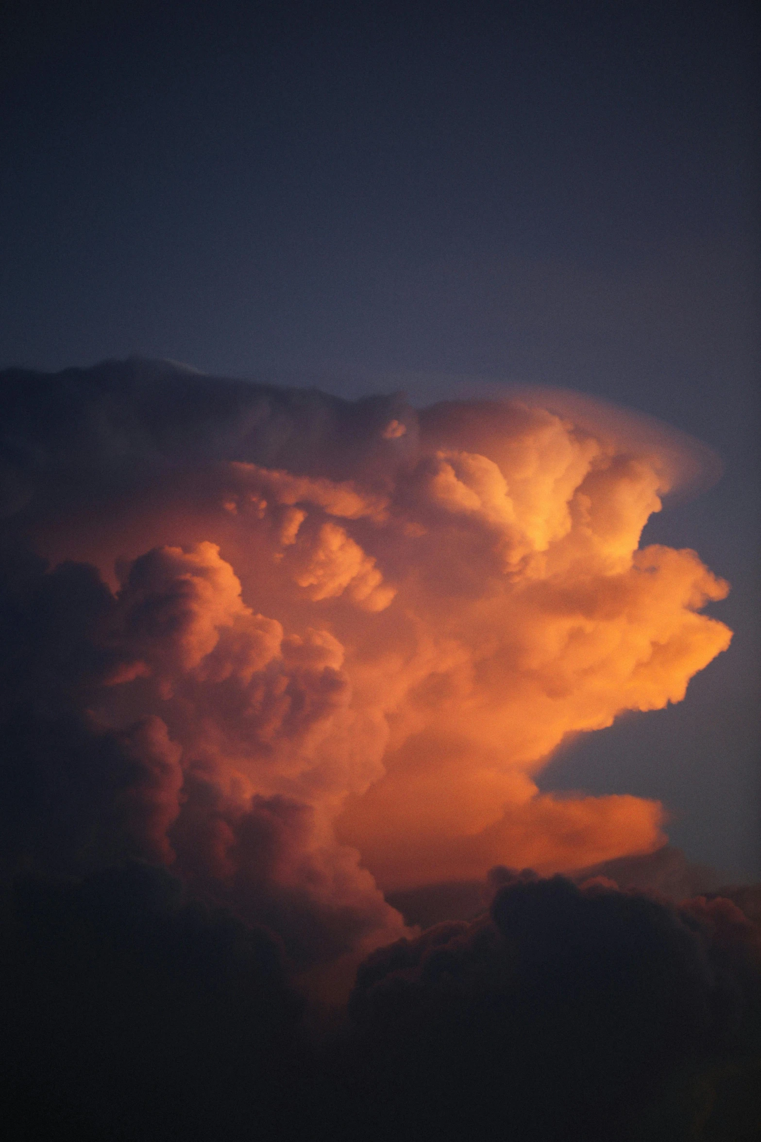 a large cloud that is in the sky, by Dennis Ashbaugh, sunset lighting ominous shadows, pareidolia, humid evening, dramatic lighting - n 9