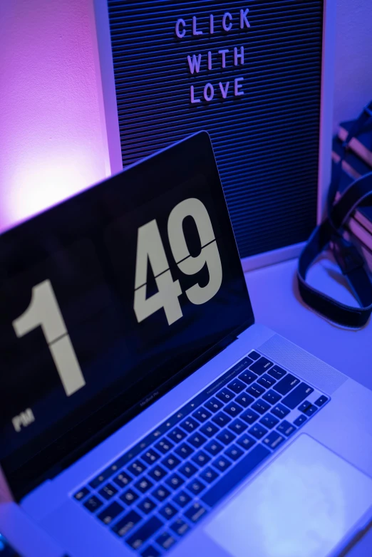 a laptop computer sitting on top of a table, by Matt Cavotta, unsplash, ascii art, clocks, 9 9 designs, soft neon purple lighting, numerical