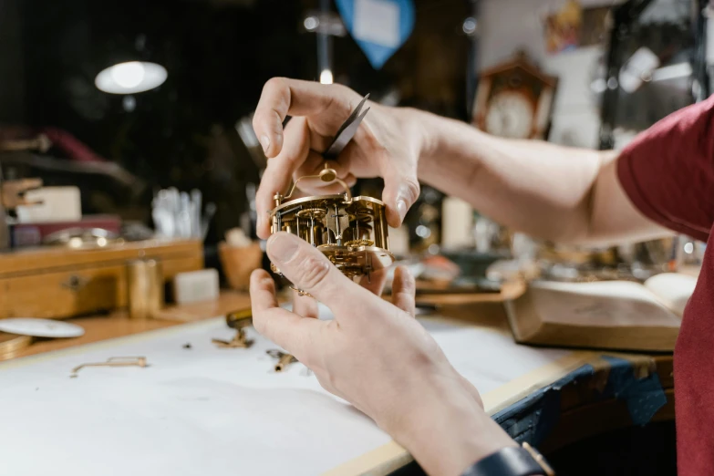 a person that is working on some kind of object, an engraving, by Jakob Gauermann, pexels contest winner, brass and wood mechanisms, avatar image, replica model, van cleef & arpels