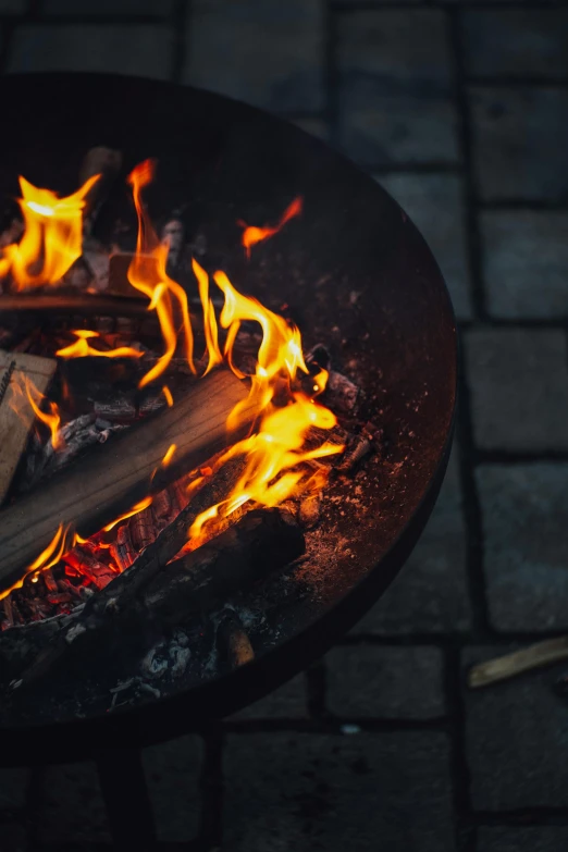 a close up of a fire in a grill, an album cover, pexels contest winner, fire pit, wok, vanilla, dark warm light