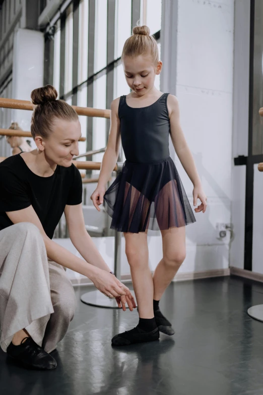 a woman teaching a little girl how to dance, by Elizabeth Durack, pexels contest winner, avant designer uniform, knee, inspect in inventory image, ouchh and and innate studio