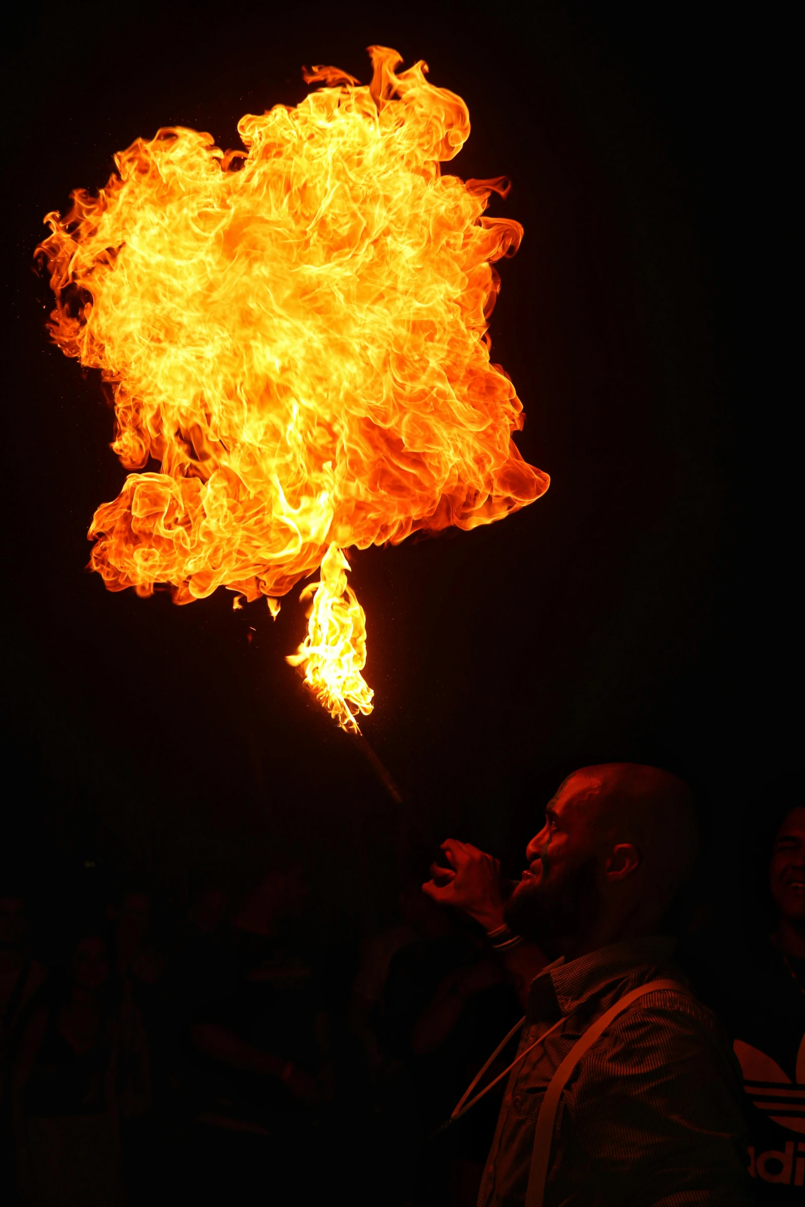 a man holding a fire stick in the dark, renaissance fair, fire breathing dragon, february), huge fire