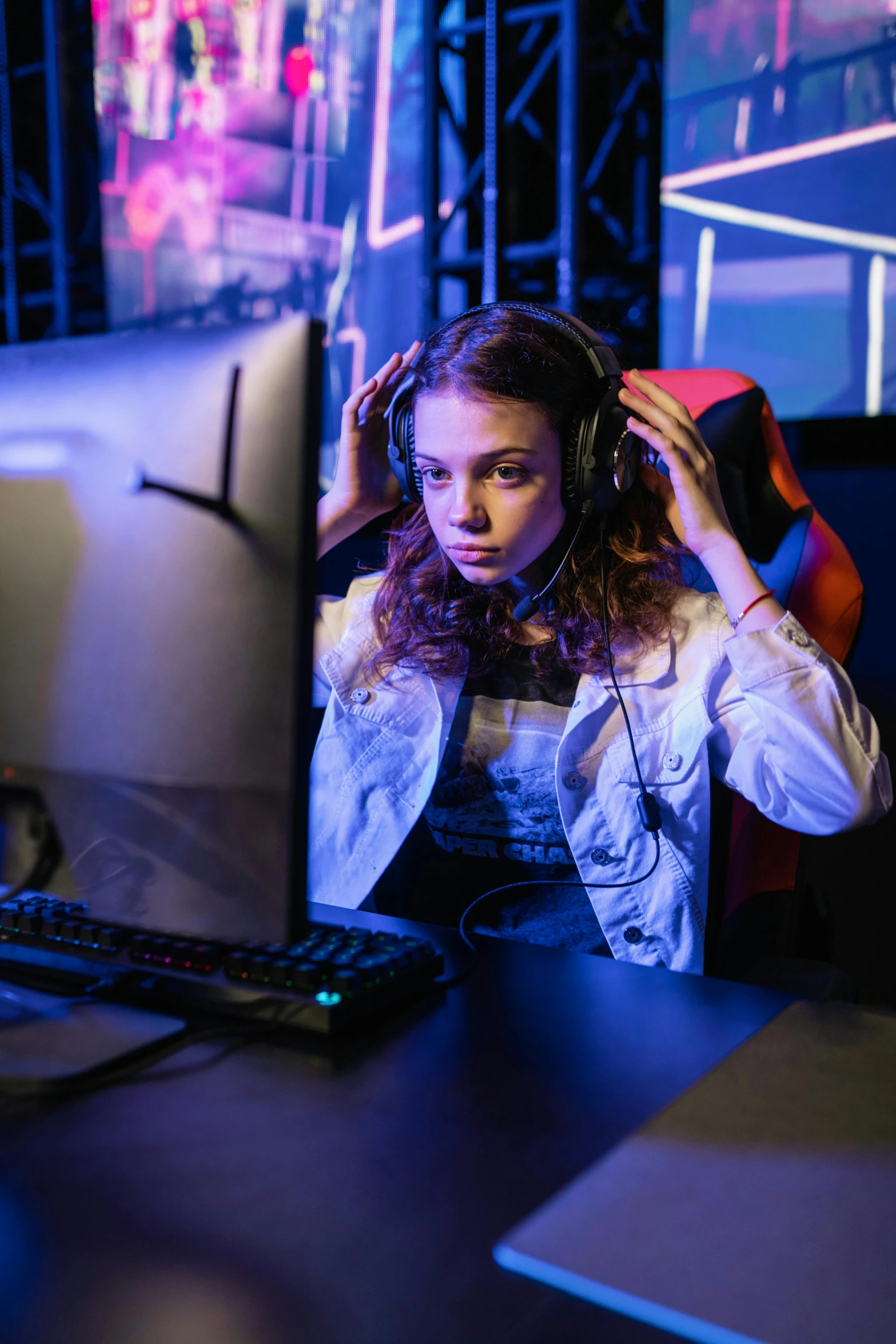 a woman sitting in front of a computer wearing headphones, game ready, tournament, 15081959 21121991 01012000 4k, age 2 0