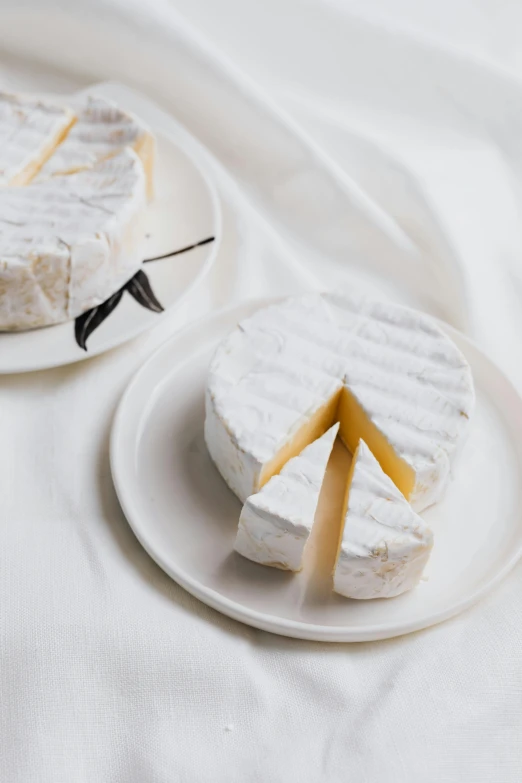 a couple of plates that have some food on them, cheese, soft white glow, uncrop, perfect crisp light