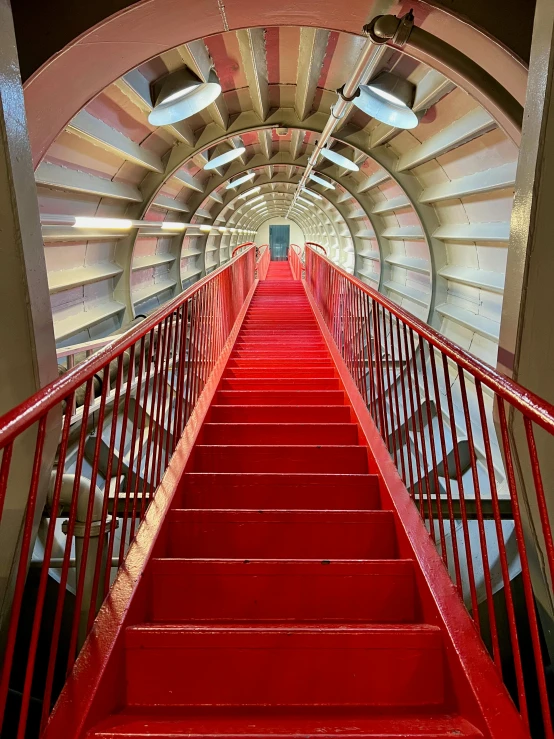 a red staircase going up to the top of a building, inside a space ship, slide show, fan favorite, camera obscura