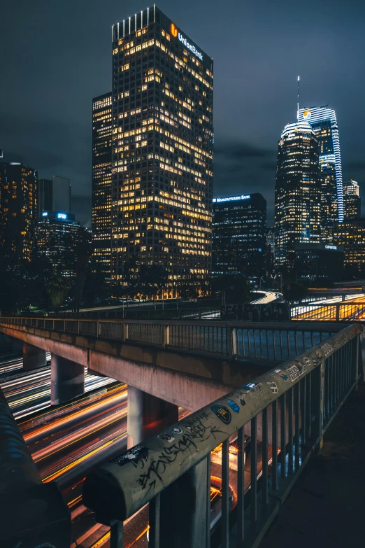 a view of a city at night from a bridge, unsplash contest winner, southern california, hyperdetailed photo, concrete jungle, traffic