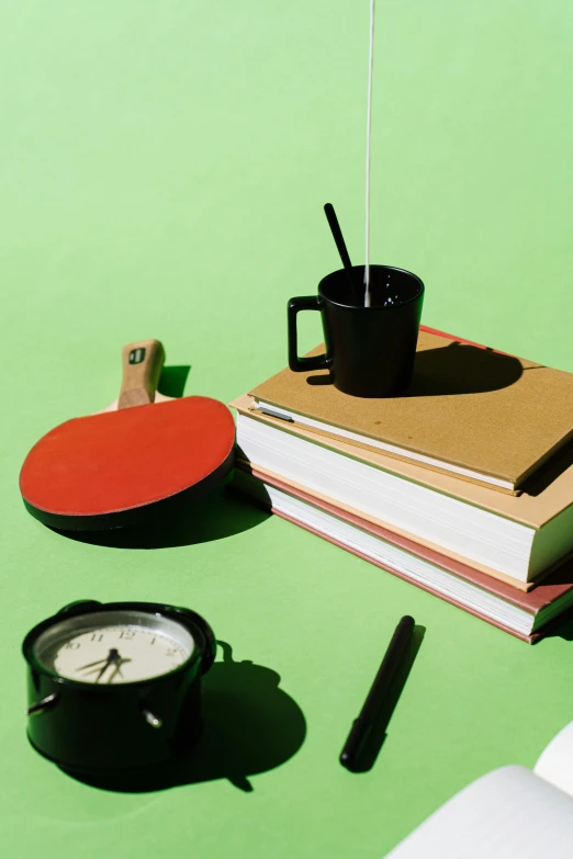 a cup of coffee sitting on top of a stack of books, a still life, trending on pexels, academic art, small clocks as leaves, markers, green: 0.5, splash image