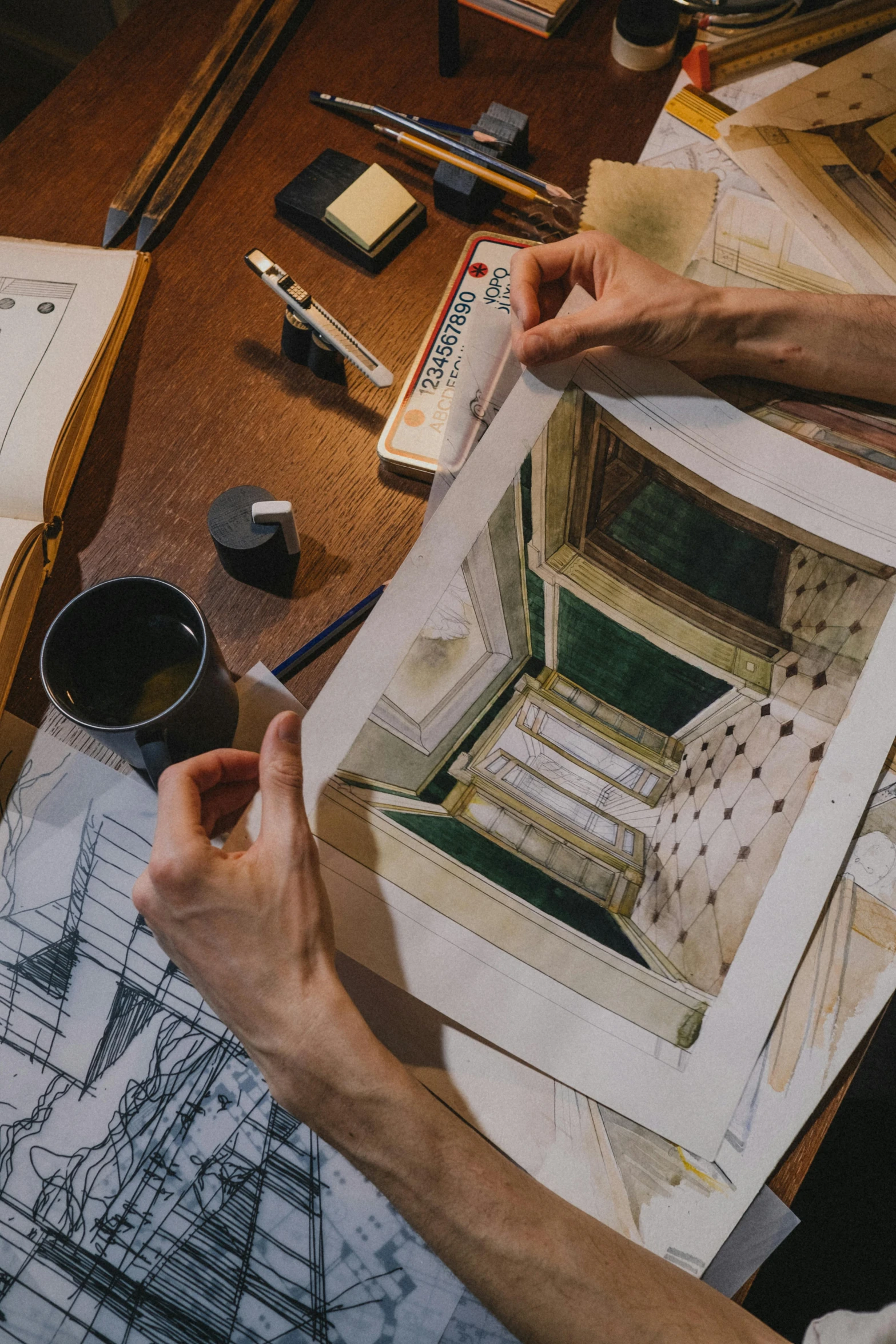 a person sitting at a table holding a piece of paper, a photorealistic painting, inspired by Richard Estes, pexels contest winner, architectural plans, taking from above, inside a grand, well - drawn