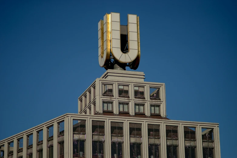 a tall building with a clock on top of it, an art deco sculpture, by Victor Enrich, unsplash, berlin secession, unreal engine 5 lighting, optimus sun orientation, soviet style, ue 6