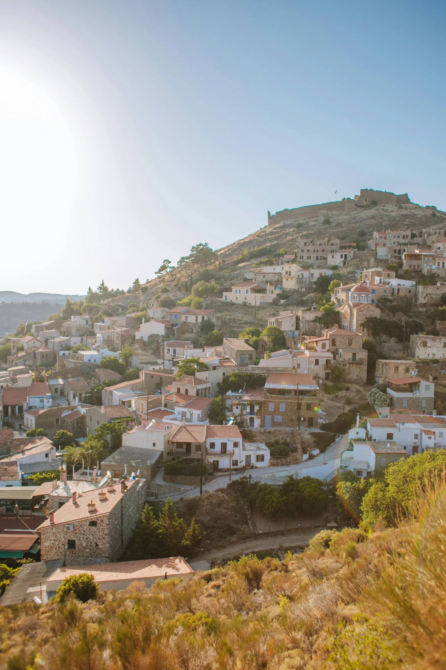 a view of a town from the top of a hill, hydra, taken at golden hour, slide show, square